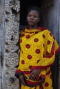 Zanzibar woman in kanga / kitenge against Zanzibar door