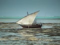 Zanzibar beach during low tide with a wooden fishing boat