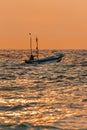 Zanzibar, Tanzania, 09 December 2021: African fishermen on a motor boat fish in the Ocean on sunset Royalty Free Stock Photo