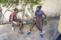 African masai men playing board checkers on a street near the tropical beach on the island of Zanzibar, Tanzania, east Africa Royalty Free Stock Photo