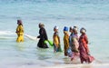 African women from a fishing village are catching small fish off the coast of the ocean