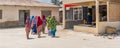 Panorama of a group of covert moslem women, backview at the street in the fishing village of Nungwi.