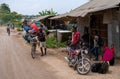 Zanzibar, Tanzania - JANUARY 2020: Black African Man with Bicycle Loaded with Good and Household Tools on Village