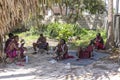 Group african men masai dressed in traditional clothes sitting near the ocean on the beach of Zanzibar island, Tanzania, East