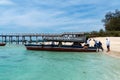 Zanzibar, Tanzania - March 15, 2023: Tourists board a boat, labeled Facebook Boat on Prison Island