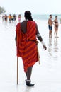 Zanzibar,Masai with typical costume walks on the beach Royalty Free Stock Photo