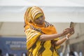 Zanzibar girl in Kanga febric taking a selfie