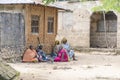 African women and children seat on the street near home of Zanzibar island, Tanzania, East Africa