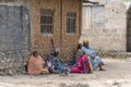 African women and children seat on the street near home of Zanzibar island, Tanzania, East Africa