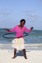 African kid playing with hula hoop on the beach Royalty Free Stock Photo