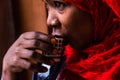 Woman having hot coffee in Zanzibar