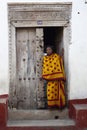 Zanzibar woman in kanga / kitenge against Zanzibar door