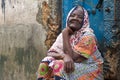 Zanzibar women greeting people as they pass her house in Stone town