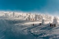 Hikers and skiers around frozen trees and rime field at the famous \