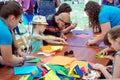 Hildren and their parents participating at arts and craft outdoors workshop