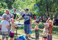 Children and their parents playing with bubbles on the meadow