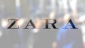Zara logo on a glass against blurred crowd on the steet. Editorial 3D rendering