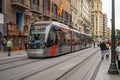 Zaragoza, Spain - April 29, 2023: Wide avenue full of people walking and tram circulating on the street.