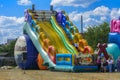 Zarechany, Ukraine - June 10, 2018. Children play on an inflatable carousel. Meeting of residents at the festival of the village