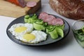 Zastrak eggs scrambled eggs sausage salad cucumbers on the trael view from the side top. Traditional English American breakfast. Royalty Free Stock Photo