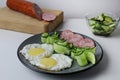 zastrak eggs scrambled eggs sausage salad cucumbers on the trael view from the side top. Traditional English American breakfast. Royalty Free Stock Photo