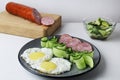 zastrak eggs scrambled eggs sausage salad cucumbers on the trael view from the side top. Traditional English American breakfast. Royalty Free Stock Photo