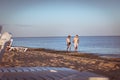 Zatoka, Odessa, Ukraine - Unidentified man and woman walk along the sand along the Black Sea coast at sunset