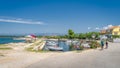 Cyclist passing small marina with moored motorboats in Zaton bay