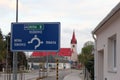 Zavar, Slovakia - April, 2011: blue pointer sign and Church of the Nativity of the Virgin Mary.