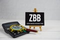 ZBB abbreviation of Zero Based Budgeting text with magnifying glass and calculator on wooden background Royalty Free Stock Photo