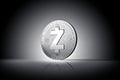 Zcash cryptocurrency physical concept coin on gently lit dark background.