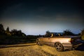 Zdimerice, Czech republic - July 22, 2020. Old convertible car parked above the city watching the night sky with comet C/2020 F3 N