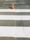 Zebra crossing marking paint and orange traffic cone