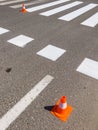 Zebra crossing marking paint and orange traffic cone