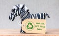 Zebra toy with Made with 100 percent reused fabric label and recycle textiles icon symbol Royalty Free Stock Photo