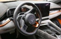 Zeekr 001 EV car interior - dashboard, player, steering wheel with logo and buttons, speedometer and tachometer. Royalty Free Stock Photo