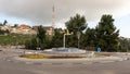 A fountain in the form of a faucet with water flowing out of it stands at a roundabout in the city of Zefat, in northern Israel