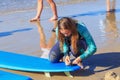 ZELENOGRADSK, KALININGRAD REGION, RUSSIA - JULY 29, 2017: Unknown young woman in wetsuit with surfboard on a beach.