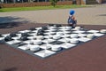 ZELENOGRADSK, RUSSIA. Boy sits on street checkers. Kaliningrad region