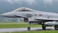 Combat military jet aircraft taxi on the runway in a raining day. Copy Space.