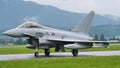 Combat military jet aircraft taxi on the runway in a raining day. Copy Space.