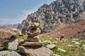 Zen balanced stones stack in high mountains. Pyramidal of stones against the backdrop of a picturesque mountain valley Royalty Free Stock Photo