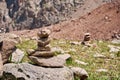 Zen balanced stones stack in high mountains. Pyramidal of stones against the backdrop of a picturesque mountain valley Royalty Free Stock Photo
