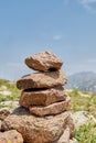 Zen balanced stones stack in high mountains. Pyramidal of stones against the backdrop of a picturesque mountain valley Royalty Free Stock Photo