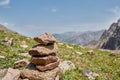 Zen balanced stones stack in high mountains. Pyramidal of stones against the backdrop of a picturesque mountain valley Royalty Free Stock Photo