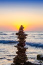 Zen Balancing Pebbles. Stack of pebbles on beach with sunrise on background Royalty Free Stock Photo