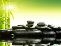 Zen basalt stones with green bamboo on water. Spa and Wellness concept. Royalty Free Stock Photo