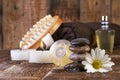 Zen basalt stones and spa oil with candles on the wood