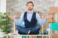 zen businessman doing yoga meditation on desk Royalty Free Stock Photo