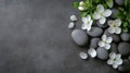 Zen composition with white flowers and gray stones on textured surface Royalty Free Stock Photo